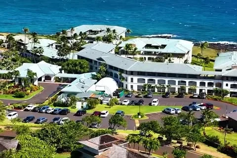 Oceanfront homes along the Kauai coastline from the air